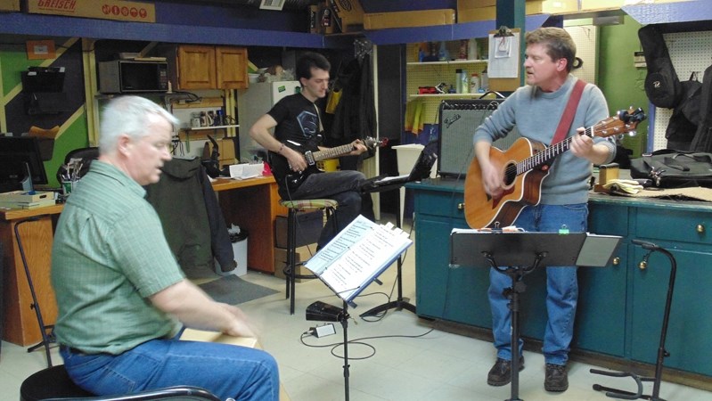 Tom Lindl, right, rehearses with T.O.A.S.T. members Jim Carroll and Jason Ross for a recent event. The local musician will be playing a solo gig at Fionn Maccools in Red Deer 
