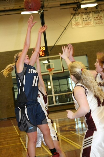 Cyclones&#8217; Haley Bedford takes a jump shot over the Didsbury Dragons in a losing cause in the Chinook&#8217;s Edge School Division championship game. The Dragons won