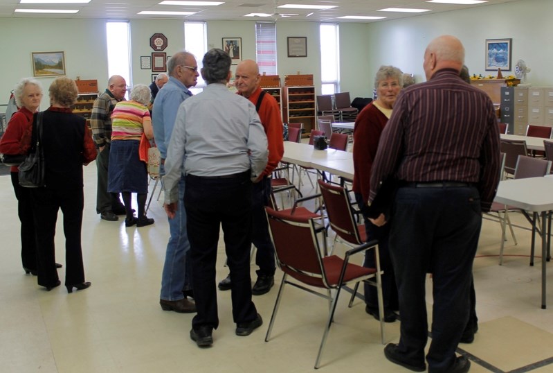 Seniors discuss the results of the Innisfail Senior Drop Inn Society meeting.