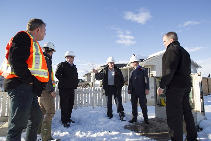 Telus officials discuss logistics of installing fibre optic cables in Didsbury last fall.