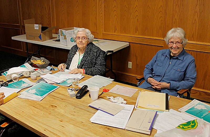 Rita Elder (left) prepares tax returns by hand for no chargea at the Royal Canadian Legion on Tuesdays while Alberta Reberger waits for a completed page.