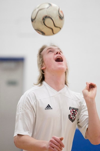 Grade 11 Innisfail Jr/Sr High provincial indoor soccer championship player Simon Bigger bounces a ball off his head during a soccer practise on March 27.