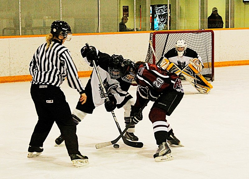 Presley Hollman, right, is in position to win the faceoff in the Central Alberta Amazons 2-1 loss to the Edmonton Wolves for the Alberta Junior Female Hockey League final on