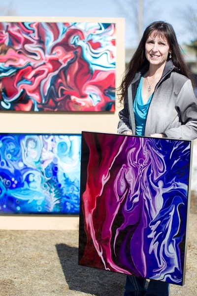 Artist Tammy Ryrie with some of her dye infused aluminum art pieces in Olds on April 9.