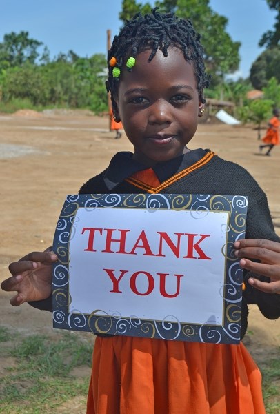 A Masakan child expresses her thanks to the nine Innisfailians who gave two weeks of their life to help her village.