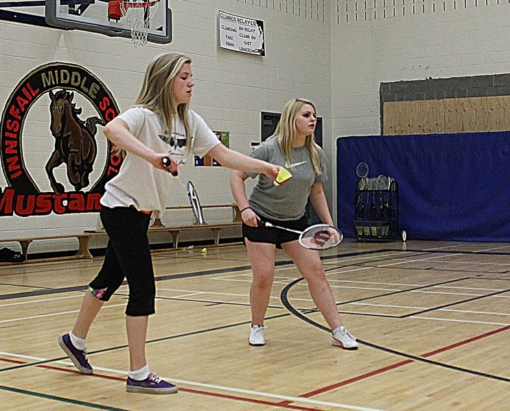 Grade 8 Innisfail Middle School girls Lexi Grant (left) and Kira Kinde practise doubles girls badminton at the Innisfail Middle School gynmasium on April 15 in preparation