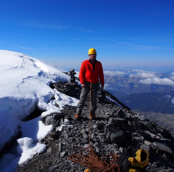 Mark McCracken atop the peak of Mt. Assiniboine