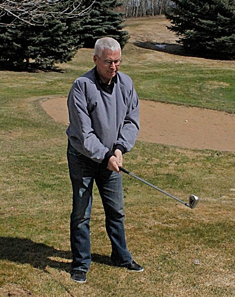 Innisfail Golf Club head professional Jim Boomer prepares to take a swing on the course to loosen winter rust from his technique.