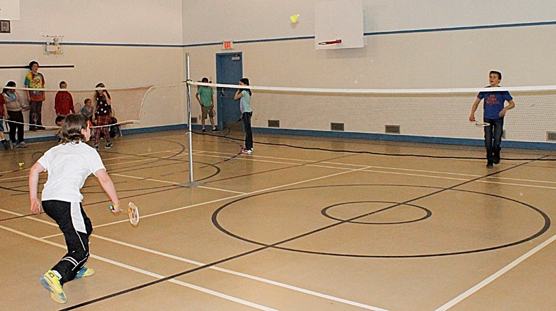 Grade 7 students Tanner Halerewich and Illya Omelyanchuk rally during a singles badminton match on April 24 at St. Marguerite Bourgeoys school.