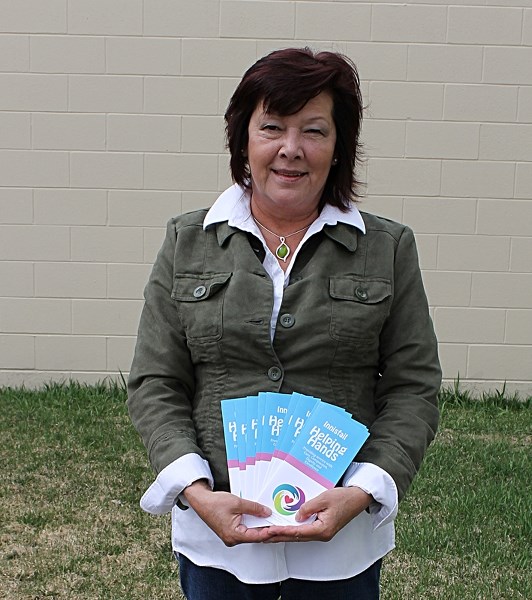 Jackie Major of Innisfail Helping Hands fans brochures for her new service in Innisfail which will open May 2.