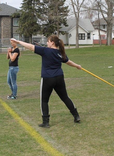 Emily Lyster (left) watches as Cherise Ek starts her throwing motion for a javelin throw at the May 14 track and field practice at the Innisfail Scholl Campus.