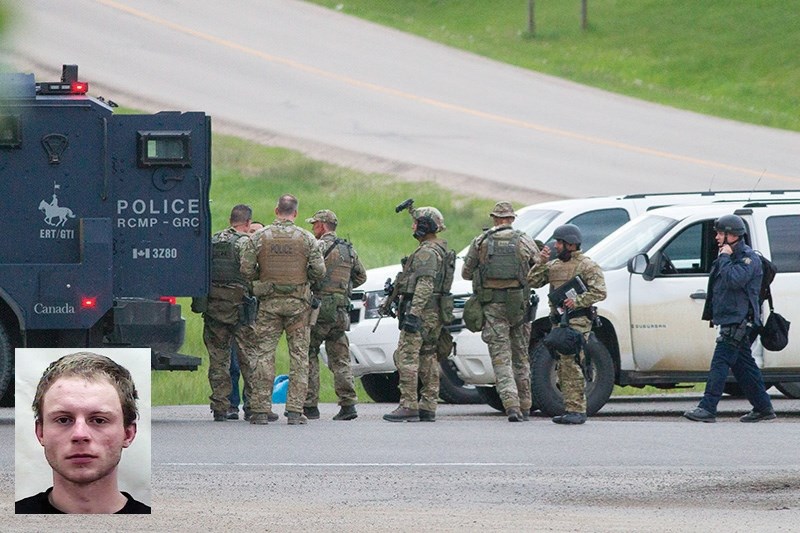 Police gear up at a command post near the interchange of highways 2 and 587 on the evening of June 12 to search for a fugitive believed to be hiding in a flower nursery north 