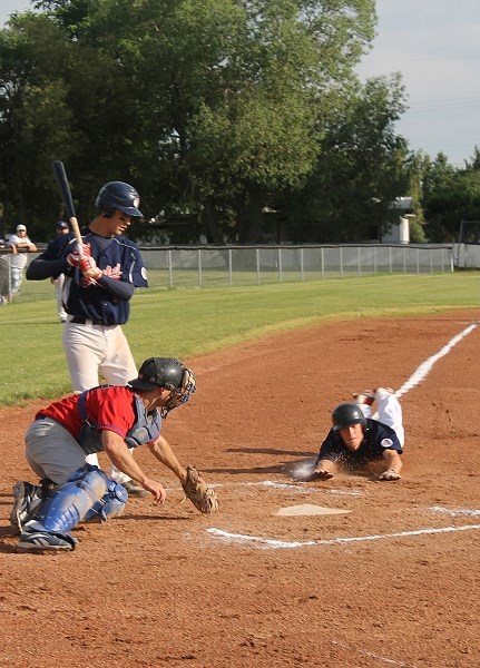 Innisfail Indian Corbyn Shields slides into home plate during their July 4th game against the Irricana Canadians.