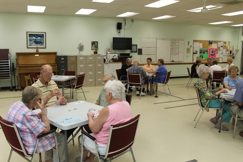 Seniors at the Innisfail Seniors Drop-In Centre play cards last week during a regular day of activity.