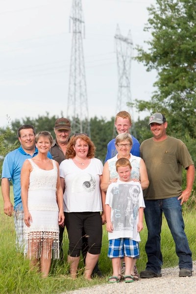 Back row from left Ivo Wachter, Harvey Lind, Jacob Stauffer; middle row from left Manuela Wachter, Kim Thompson, Ruth Lind; and front row Chris Thompson in front of power