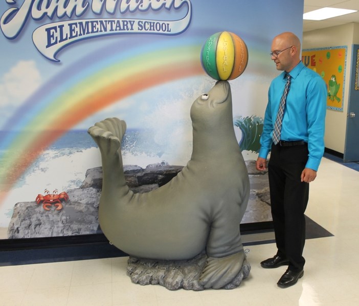 New école John Wilson Elementary School principal Jason Drent stares down the school mascot on Aug. 26.