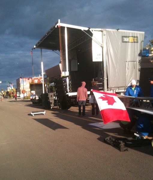 Tour officials prepare for stage two of the Tour of Alberta in downtown Innisfail.