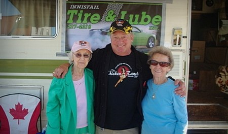 Gordie Bonin (centre) poses with his mother Marie Bonin (left) and Ruby Anderson in front of Stoski&#8217;s trailer at the registration booth for the Weekend of Wheels last