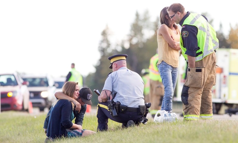 Police attend the scene of an automobile accident on QEII near Ole Pole Road.