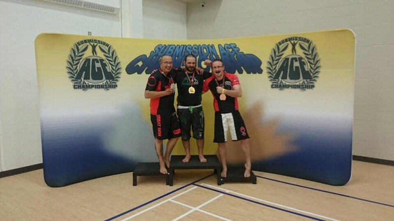 Ossie Wozny (centre) won gold in the Summer Nogi Submission Ace Championships held in Blackfalds on Sept. 6.