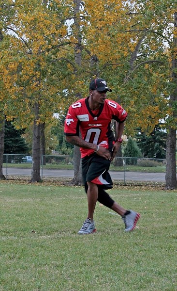Calgary Stampeder player Quincy Butler demonstrates proper defensive back technique to young Innnisfail and area football players on Sept. 18 during a special practice.