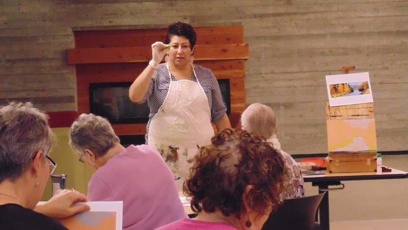 Innisfail artist Osi Cruz-Lahtinen suggests a colour of pastel to practice with during her adult workshop at Innisfail Public Library&#8217;s 2014 Arts Fest event.