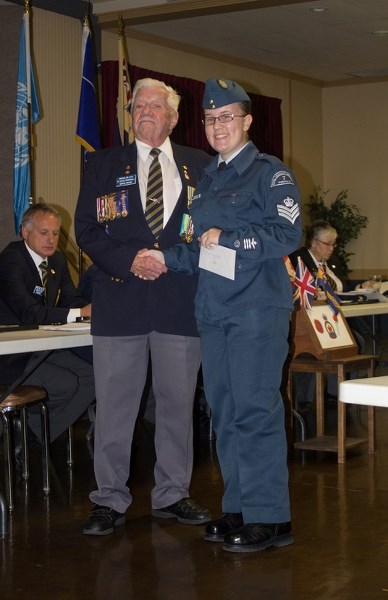 Veteran Doug Whorrall presents Sgt. Katrina Pannenbecker of Penhold Air Cadet Squadron #7 with a bursary on Sept. 23.