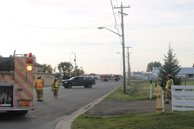 Firefighter crews arrive at the corner of Lucina Street and Robinson Avenue in Penhold after a fibre optic line was pulled down. Internet and telephone services were