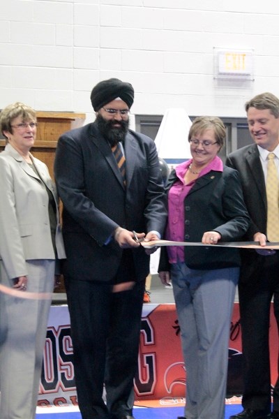 Manmeet Bhullar, government infrastructure minister, cuts the ribbon on Penhold Crossing Secondary School while Colleen Butler, chair of the Chinook&#8217;s Edge School