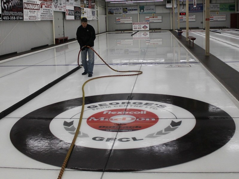 Innisfail Curling Club icemaker Brent Asham floods the ice in preparation for the 2014-15 curling season.