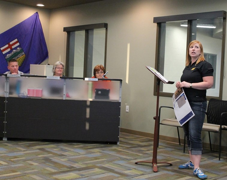 Melissa Grant (right) speaks to Penhold town council on the proposed upgrade to the town website on Oct. 14 during its regular meeting.