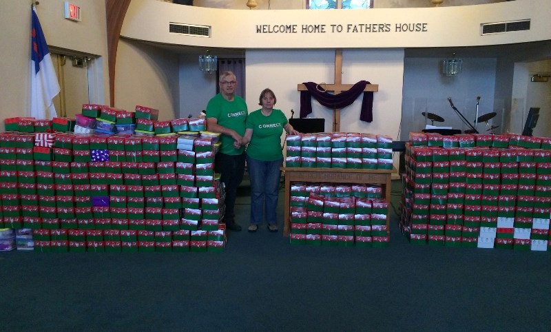 John and Dorothy Fehr pose in front of the nearly 500 Operation Christmas Child boxes gathered last year.