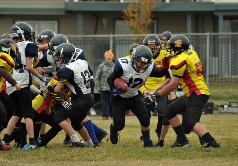 The Cyclones&#8217; Gage Caron attempts to stiff-arm Drumheller&#8217;s AJ Kolm while rushing the football during Innisfail&#8217;s game against Drumheller. The Cyclones lost 