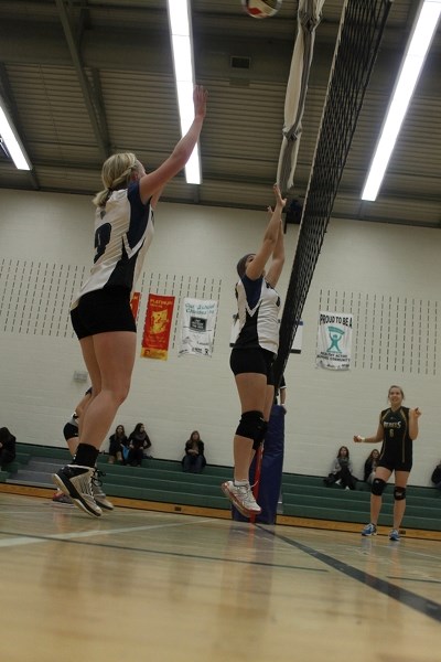 Elizabeth Maciborsky (left) and Ciara Foster jump to block during their sixth- place playdown held on Nov. 5 between Innisfail, Ponoka and Rocky Mountain House.