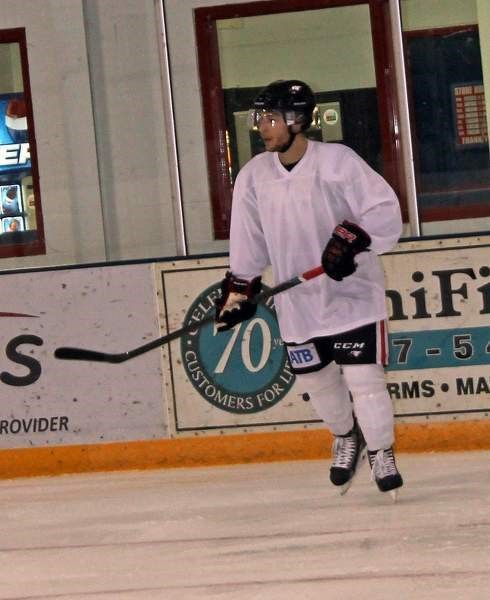Brendan Baumgartner (left) waits for his opportunity to join a hockey drill during the Nov. 18 Eagles practice.