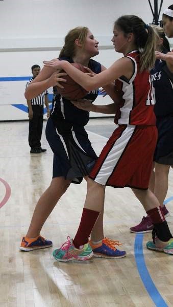 The Grade 9 Cyclones&#8217; Taylor Emerson stares down a Lindsay Thurber Comprehensive High School player during their 46-12 loss to the Red Deer team on Dec. 3.