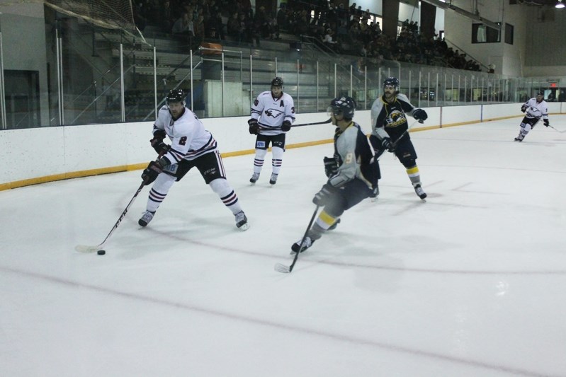 Eagles&#8217; Andrew Bergmann prepares to pass in front of the Stony Plain net with Jordan Ceh watching him closely in the visitor end of the rink of the first period.