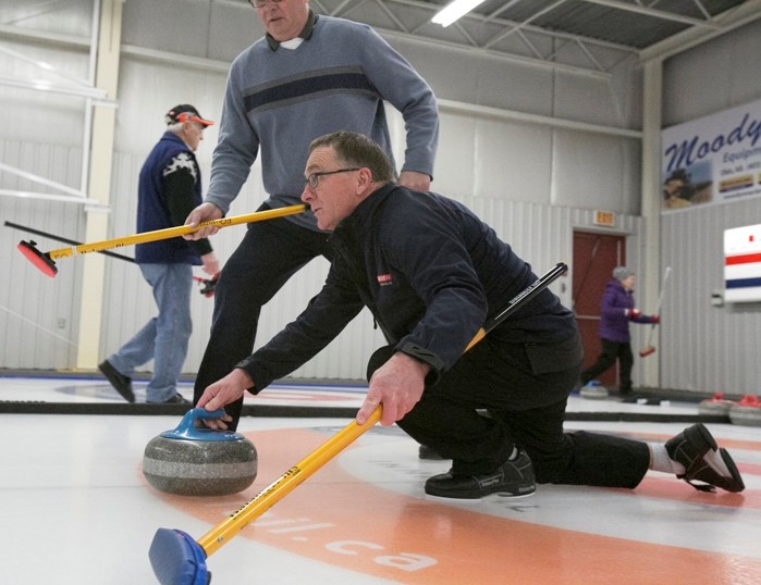 Don Smith throws a rock during the Innisfail Seniors Open Bonspiel that was held Jan. 4 to 8 at the Innisfail Curling Rink.