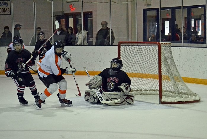 A member of the Innisfail Legion Flyers peewee team gets in front of the net during an exhibition game against the Red Deer Chiefs in Innisfail on Jan. 3.