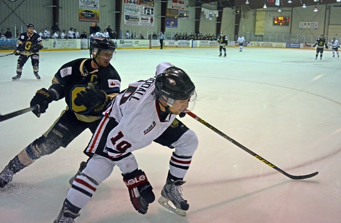 Innisfail Eagles forward Clayton Goodall, front, keeps his eyes on the puck along the boards during a game against the Bentley Generals Friday in Innisfail. The Eagles lost