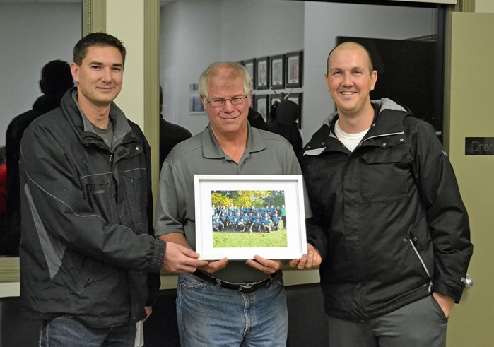 Bowden Grandview Blazers football team defensive coach Adam Neale (left) and head coach Chris Grudeski (right) present Bowden mayor Robb Stuart (centre) with a team photo. In 