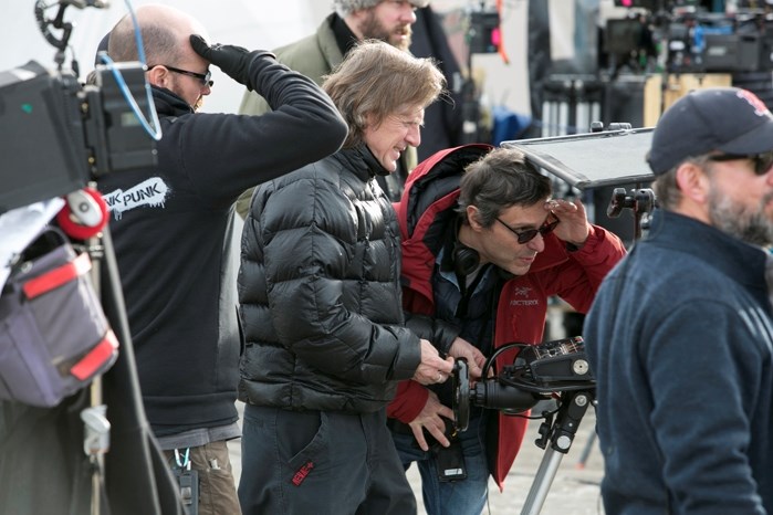 Camera operator Carey Toner, middle left, and director Paulo Barzman, middle right, view the scene through a remote monitor connected to a video camera.