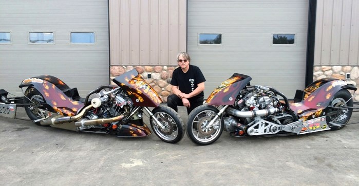 Motorcycle mechanic and crew chief for ASB Racing, Don Newlove of Bowden, stands next to two nitro (drag racing) motorcycles he recently built. The bikes are two of the
