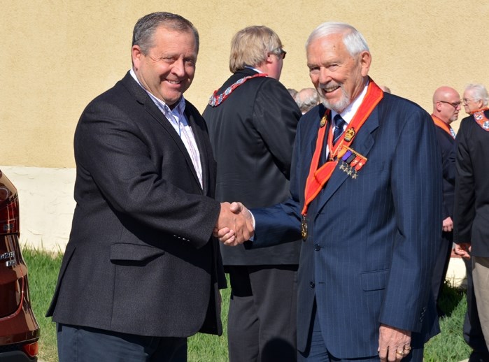 Innisfail mayor Brian Spiller greets William Johnston, most worshipful brother, past grand master of the Orange Lodge of Canada during the Orange Lodge annual general meeting 