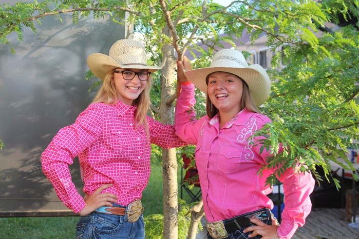 From left, Kyla Kelly and Amy Shuckburgh pose together under a tree.