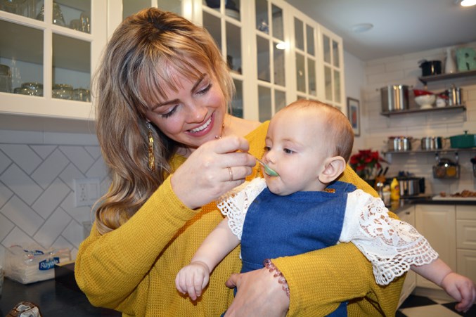 Brittany Lundy feeds her infant daughter June Johansen, who was born with cCMV.