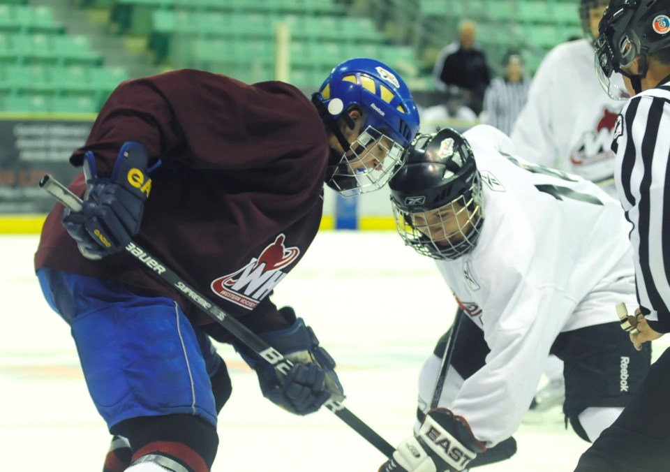 Spencer Kryczka of Calgary, left, goes up against Kolten Anderson of Lloydminster, right, during this year&#8217;s Rebels training camp.