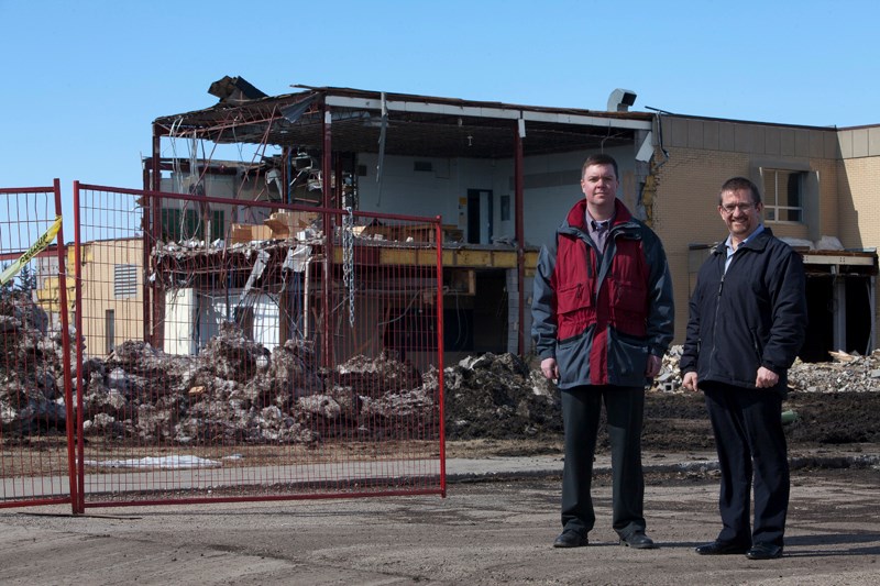 Craig Teal and Norm McInnis at the old location of Olds High School. The land will feature prominently in redevelopment of Olds&#8217; uptown.