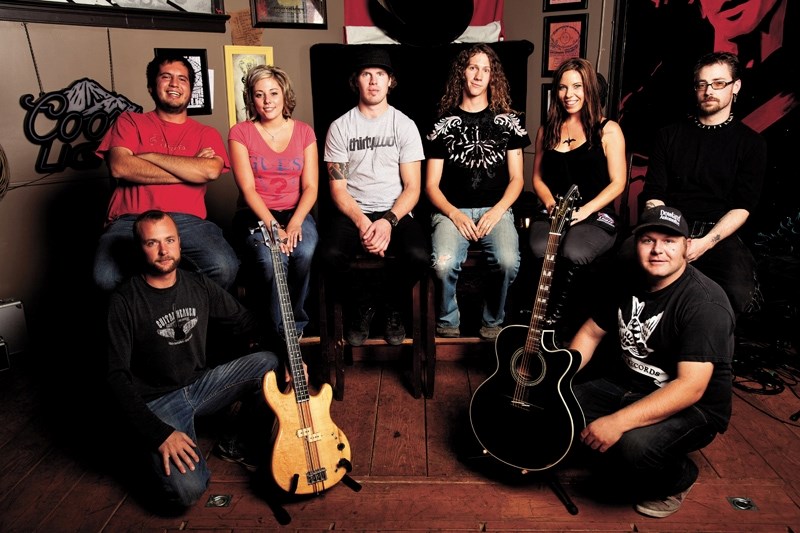 Tracks Pub staff and band members appearing this Saturday mix on the stage where the magic happens. Back row from left: Warren Venne (member of Nobodys Shadowand bartender),