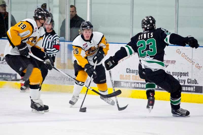 Grizzlys player Hunter Stewart attemps to get past a Drayton Valley Thunder player during their game at the Olds Sportsplex last Friday. Drayton Valley won the gaame 3-0.